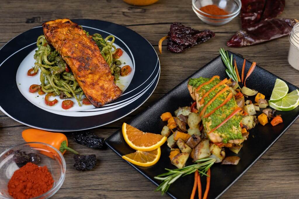 Delicious salmon dishes with pasta and roasted vegetables, perfect for gourmet dining.