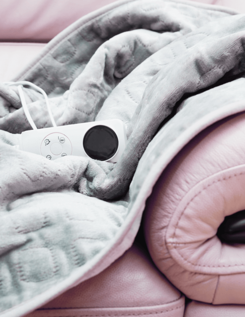 Gray blanket on pink couch.