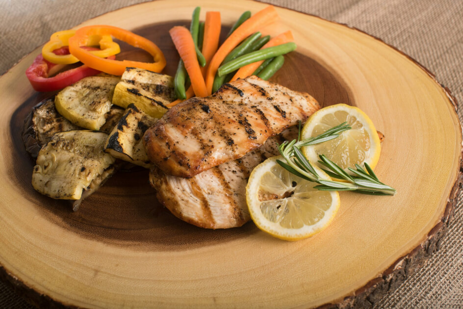 Chicken breast fillets on a plate with lemon slices