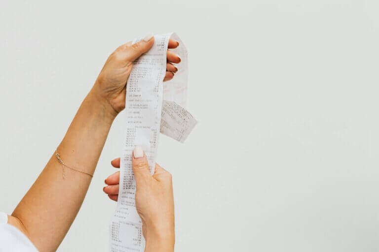 A woman's hands holding a receipt.