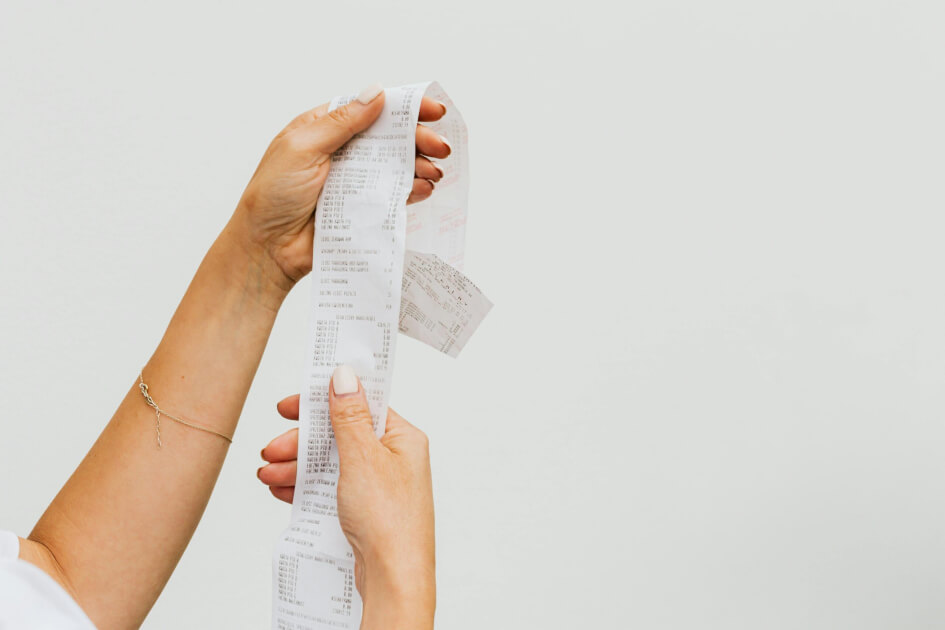 A woman's hands holding a receipt.